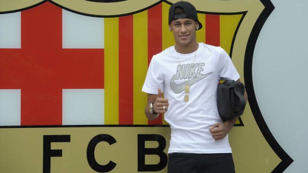 Neymar gestures upon his arrival at the club's office at the Camp Nou stadium in Barcelona, Spain.