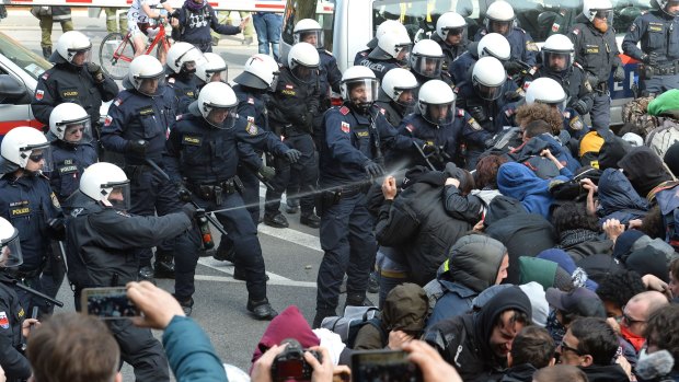Police use pepper spray on protesters in the village of Brenner on the Italian-Austrian border.