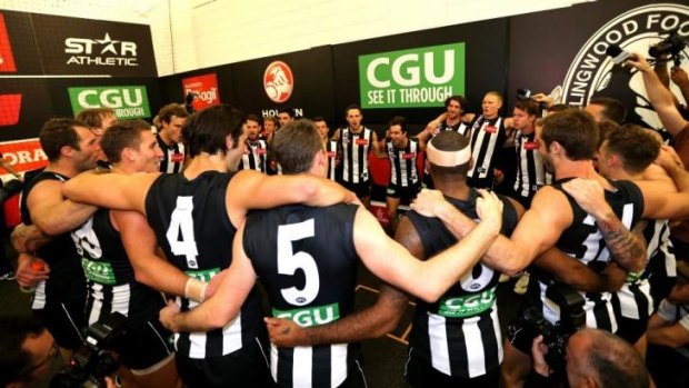 Magpie joy: Collingwood players sing the song. 