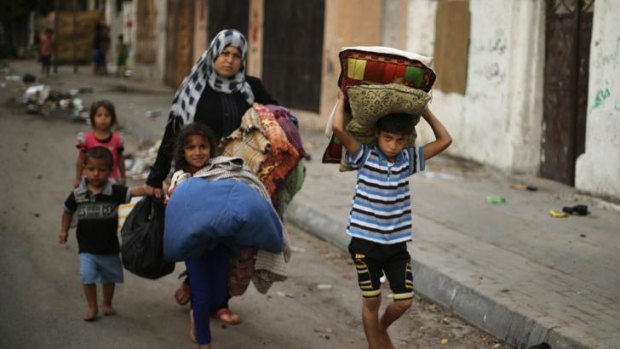 Palestinians flee their house from what witnesses said were Israeli air strikes on Tuesday.