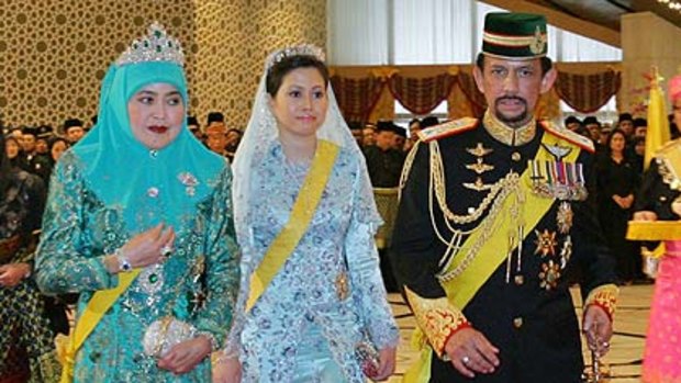 Brunei's Sultan Hassanal Bolkiah  with first wife Queen Saleha  and second wife Azrinaz Mazhar Hakim, right.
