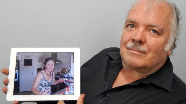 Mark Hutchings with a photo of his late daughter Sharon Camisa, who died from Legionnaires Disease.
