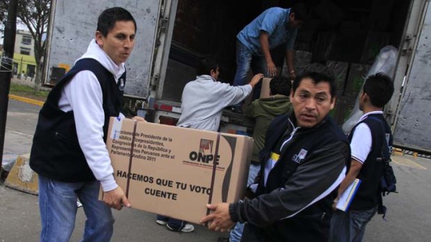 Electoral workers unload ballot boxes at a polling station ahead of Sunday's elections in Lima.
