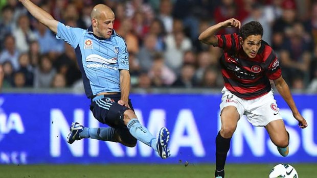 Core value ... Sydney FC's Trent McClenahan forces Jerome Polenz to take evasive action during their clash at Parramatta Stadium. <em>Photo: Supplied</em>