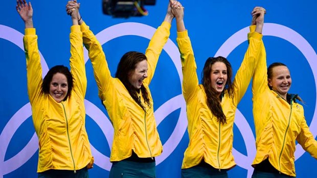 Our first gold ... Alicia Coutts,  Cate Campbell,  Brittany Elmslie and Melanie Schlanger step up on to the podium to receive their medals after winning the 4x100m relay.
