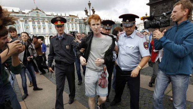 Police detain a gay rights activist Kirill Kalugin during his one-man protest in St. Petersburg.