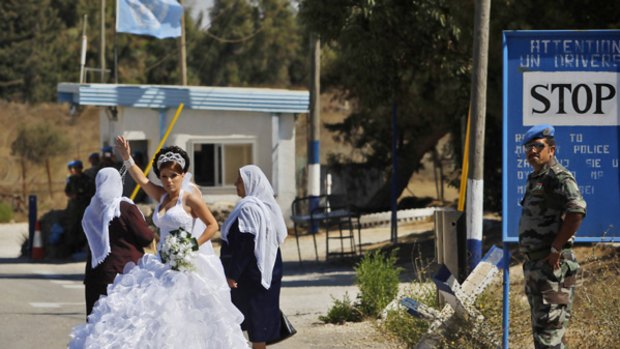 An Israeli-Druze bride crosses the United Nations buffer zone from Israel into Syria in the disputed Golan Heights for her wedding. Once across, she is not allowed back.