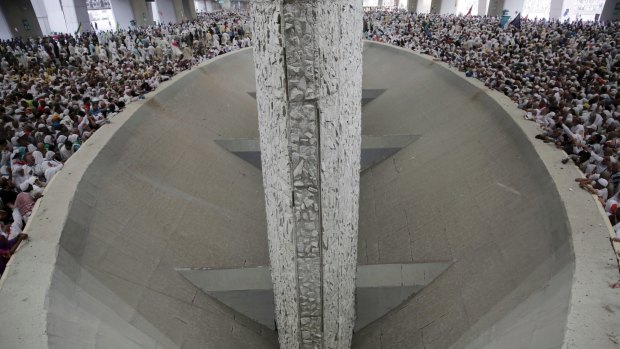 Muslim pilgrims cast stones at three huge stone pillars in the symbolic stoning of the devil, outside the holy city of Mecca, Saudi Arabia, on Saturday.