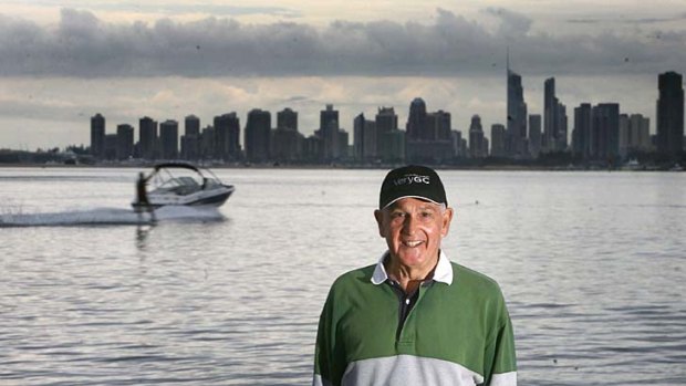 Gold Coast Mayor Ron Clarke poses in front of the early morning backdrop of Surfers Paradise.