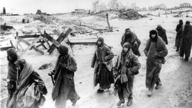 Misery ... captured German soldiers make their way through the ruins of Stalingrad.