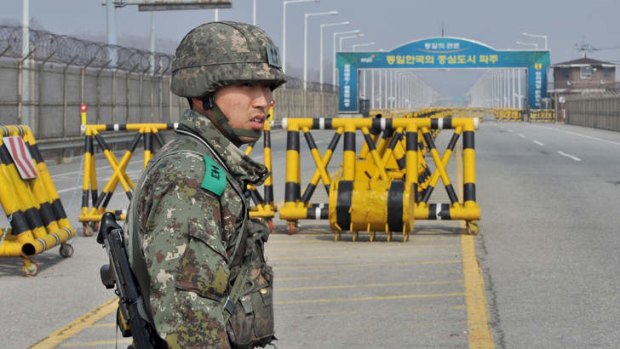 A South Korean soldier stands on a road linked to North Korea at a military check point in Paju near the demilitarised zone.