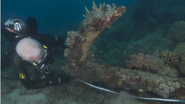 An anchor discovered off Lizard Island is measured by a diver from the National Maritime Museum.