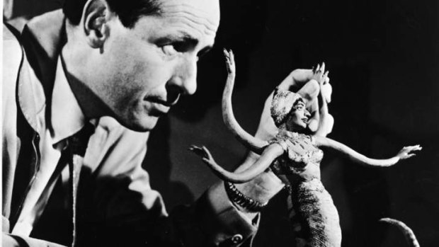 Ray Harryhausen manipulates a figure of a serpent-like monster for stop-motion animation, circa 1965.
