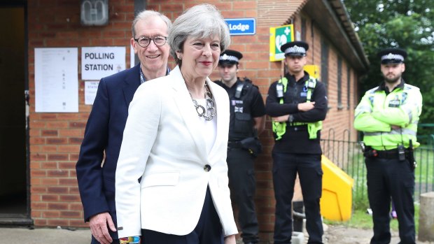 Conservative Party leader Theresa May and husband Philip arrive at a polling station to vote on Thursday.