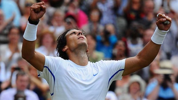 Defending Wimbledon champion Rafael Nadal clenches his fist after defeating Andy Murray to move through to successive finals.
