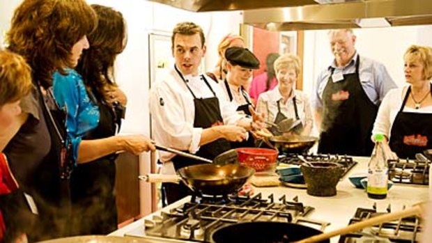 Stirring supervision ... students get to grips with the intricacies of Thai cuisine at the Sticky Rice Cooking School.