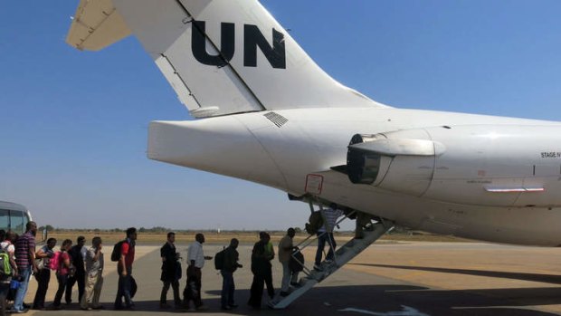 United Nations' non-critical staff boarding a United Nations plane to be taken away from Juba.