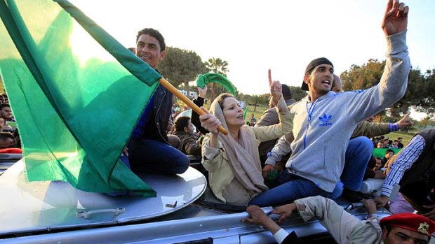 Backing her father ... Aisha Gaddafi waves a Libyan flag.