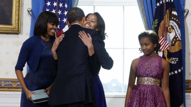 Nice one, Dad &#8230; Barack Obama gets a hug from his daughter Malia on Sunday.