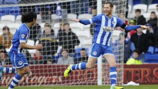 The opener: Wigan's Chris McCann celebrates taking the lead against Cardiff City.