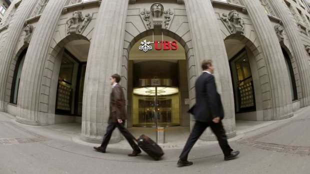 People walk past the headquarters of Swiss bank UBS in Zurich.