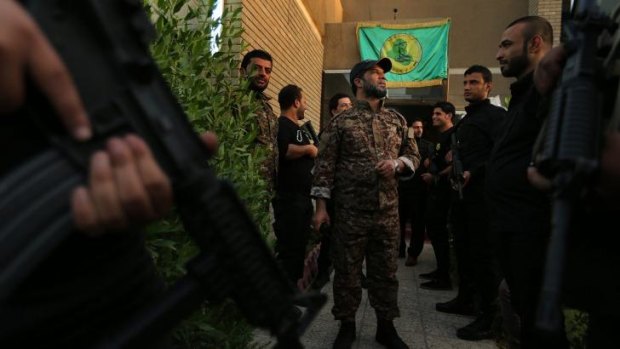 Don't call them militias: Haji Jaafar al-Bindawi (centre) with his men at the Imam Ali Brigade's headquarters in Baghdad.