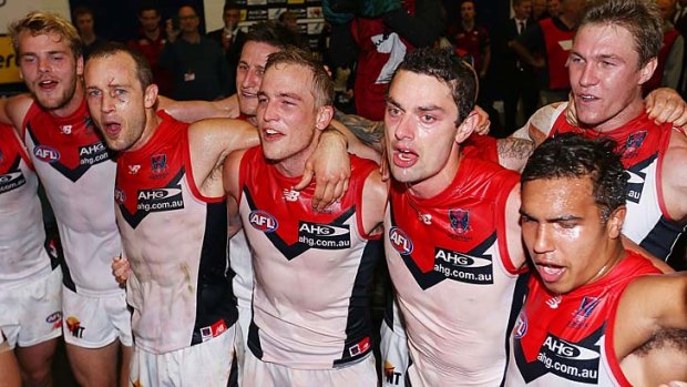 Melbourne players celebrate a win after a long time.