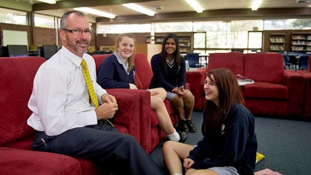 Classy approach: Templestowe principal Peter Hutton in the resource centre with Sarah Fraser (left), Semira Vandayar and Kyra Mallia (front).
