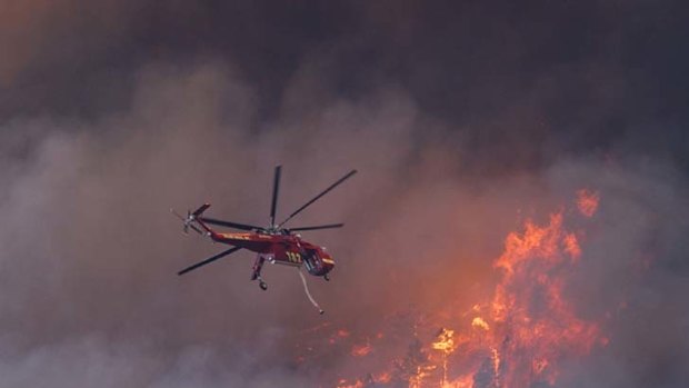 "An apocalypse" ... a helicopter tries to put out a fire as it moves towards Colorado Springs.