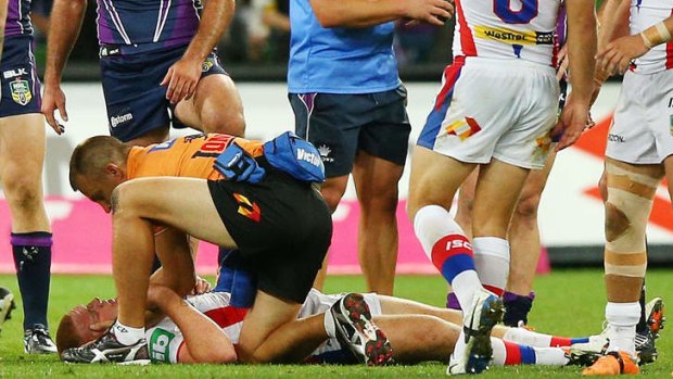 Chilling scenes: Newcastle's Alex McKinnon is treated after being driven head-first into the ground by Melbourne forwards Jordan McLean and Jesse and Kenny Bromwich at AAMI Park on Monday night.