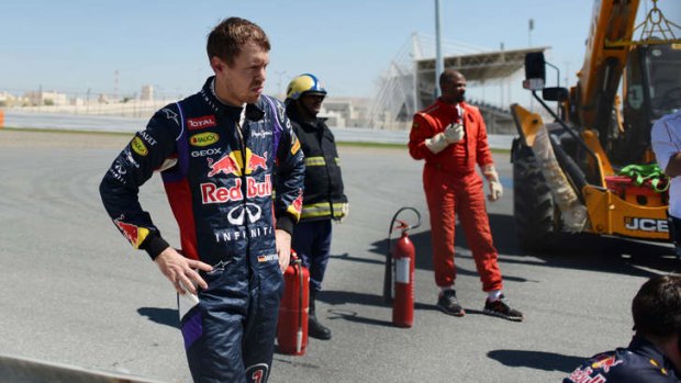 Difficulties: Sebastian Vettel looks on after his car broke down during pre-season testing in Bahrain.