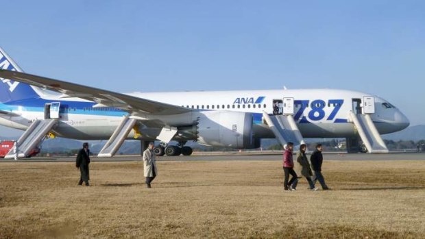 Passengers walk away from All Nippon Airways' (ANA)  Dreamliner plane that made an emergency landing at Takamatsu airport, western Japan, on Wednesday.