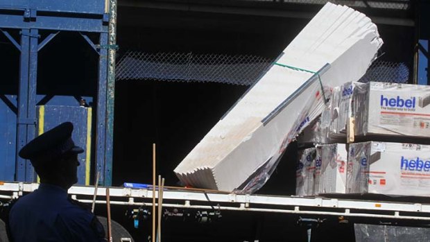 A slab of concrete fell while being lifted by a crane, hitting a worker below.