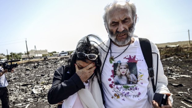 Perth couple George Dyczynski and Angela Rudhart-Dyczynski look over the wreckage of the crashed aircraft in Ukraine.