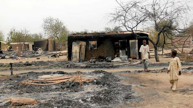 Children walking outside a charred house in the remote northeast town of Baga after an attack early this month blamed on Boko Haram.