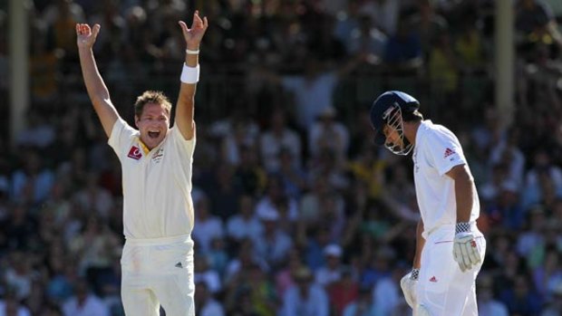 Ryan Harris, left, celebrates the wicket of Alastair Cook in Perth.