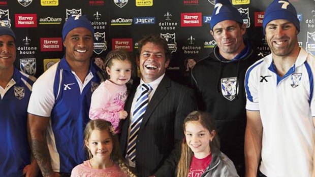 Time to go ... Brett Kimmorley, flanked by  his teammates and his daughters Ava, Mia and Maddi, announced his retirement yesterday.