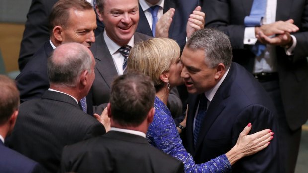 Business has praised a "softer, cuddlier budget" from Treasurer Joe Hockey, seen here congratulated by Foreign Affairs Minister Julie Bishop after handing down the Budget.