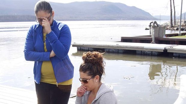 Paying their respects ... Natasha Colon, left, and Nicole Callahan, visit a memorial at the boat ramp where LaShanda Armstrong drove her minivan into the Hudson River.