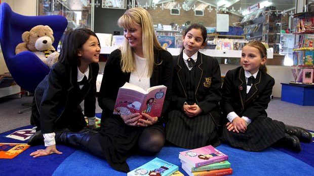 Novel approach to teaching &#8230; Jacqueline Harvey shows Jemma Tran, Shaniece Antoon and Ruth Alexander the latest book in the Alice-Miranda series.