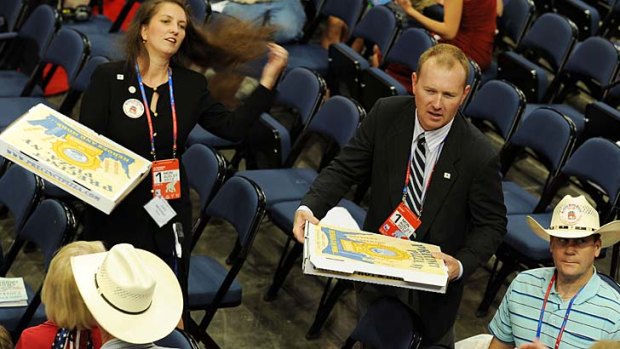 Texas delegates break out boxes of pizza on the convention floor shortly after Republican National Convention Chairman Reince Priebus adjourned the convention right after convening it.