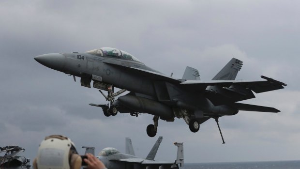 A US Navy F/A-18 Super Hornet fighter approaches the deck of the USS Carl Vinson, whose diversion towards the Korean peninsular has provoked Pyongyang.