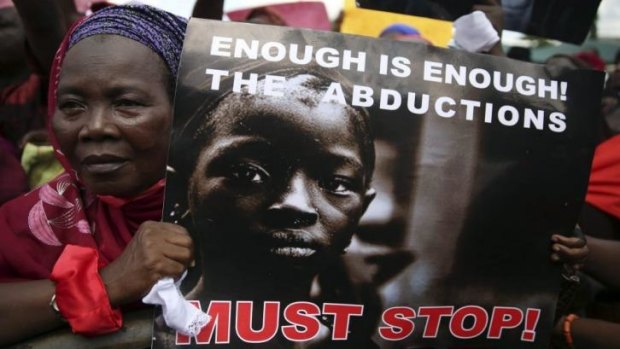 A woman holds a sign during a protest demanding the release of abducted secondary school girls from the remote village of Chibok, in Lagos, Nigeria. 