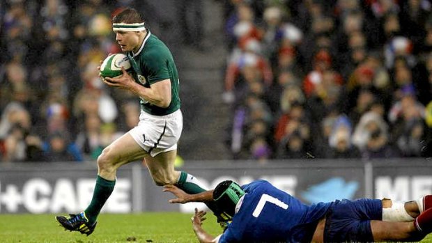 Brian O'Driscoll of Ireland evades a tackle by Thierry Dusautoir.