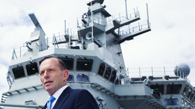 Tony Abbott has demonstrated his abilities as a team player. He is seen here as prime minister, on the HMAS Canberra flight deck before its commissioning ceremony.