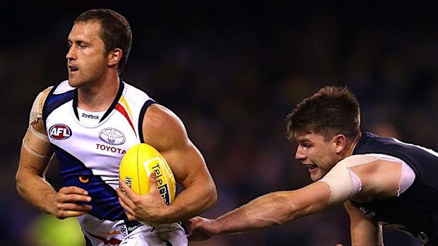 Frustrated Blues: Adelaide's Jason Porplyzia marks in front of Carlton's Bryce Gibbs.