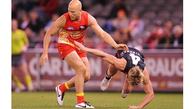 Falling into place: Suns star Gary Ablett gets rid of St Kilda tagger Clinton Jones during Sunday's game at Etihad Stadium.