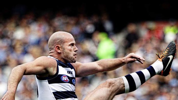 Cats midfielder Paul Chapman kicks for goal.