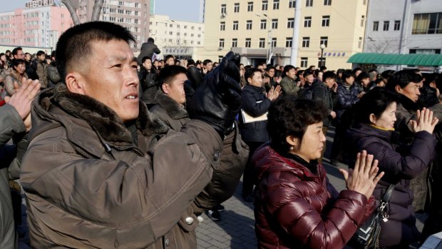 North Koreans watch the nuclear test news broadcast on a video screen outside Pyongyang Railway Station in North Korea on Wednesday.