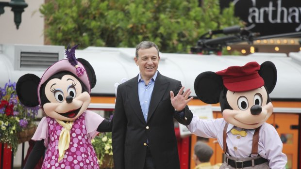 Disney CEO Robert Iger with Minnie Mouse and Mickey Mouse: Will he extend his tenure now?